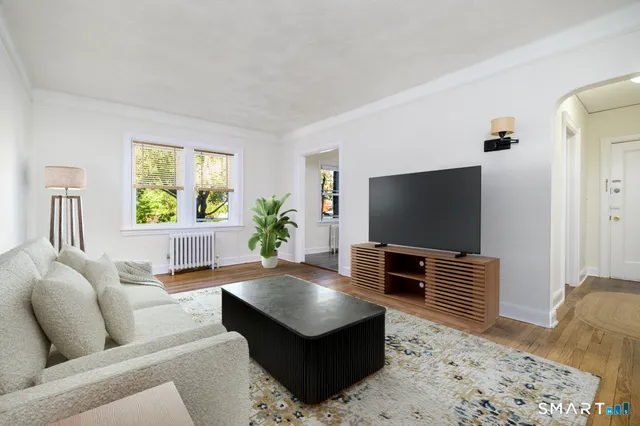 a living room with furniture and a flat screen tv