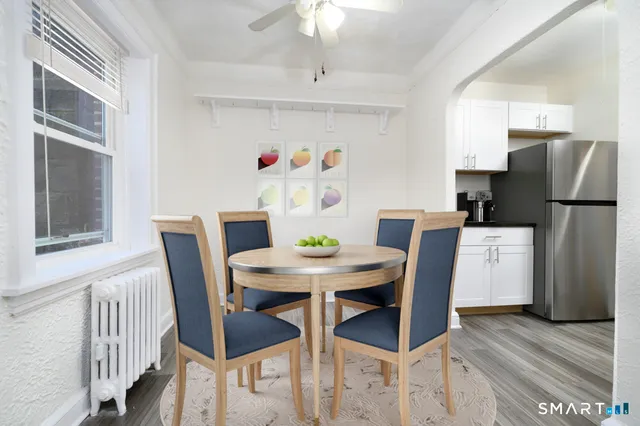 a view of a dining room with furniture and a chandelier