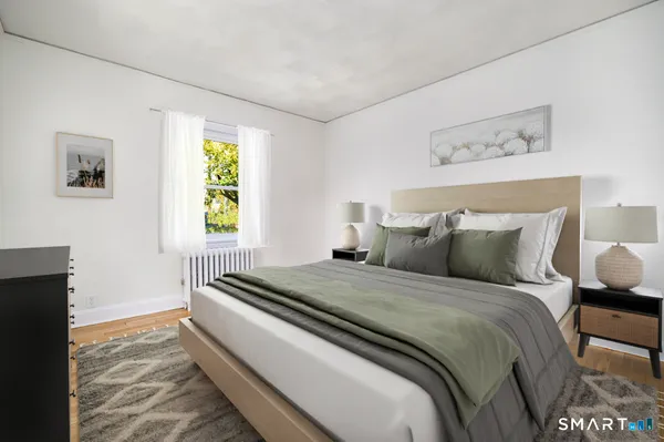 a bedroom with bed and window