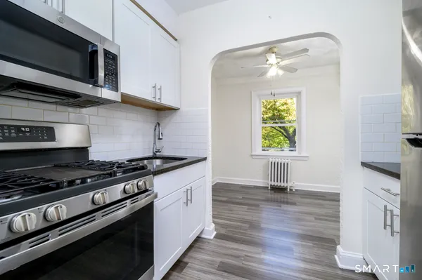 a kitchen with stainless steel appliances granite countertop a stove and a microwave