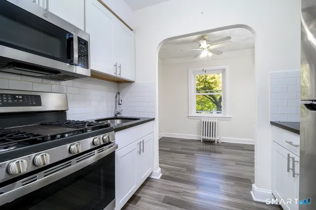 a kitchen with stainless steel appliances granite countertop a stove and a microwave