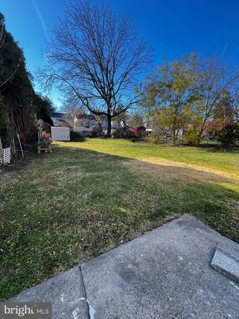 a view of yard with swimming pool and trees