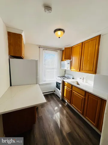 a kitchen with stainless steel appliances a stove a sink and a refrigerator