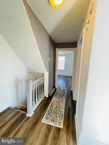 a view of hallway with wooden floor