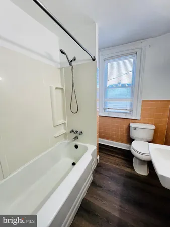a bathroom with a bathtub and a toilet