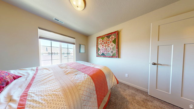 1674 Eastridge Road Price, UT 84501 - Photo 26 of 34 Spacious room featuring a large window, neutral wall paint, textured carpeting, and a contemporary two-panel interior door