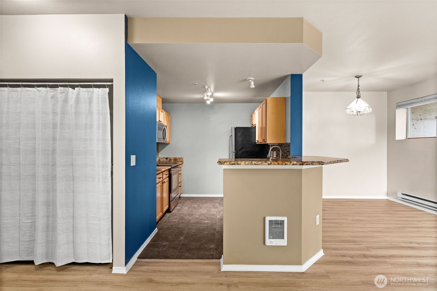6137 Hazel Loop Southeast, Unit A8 Auburn, WA 98092 - Photo 12 of 40 a view of kitchen with stainless steel appliances wooden floor and chair