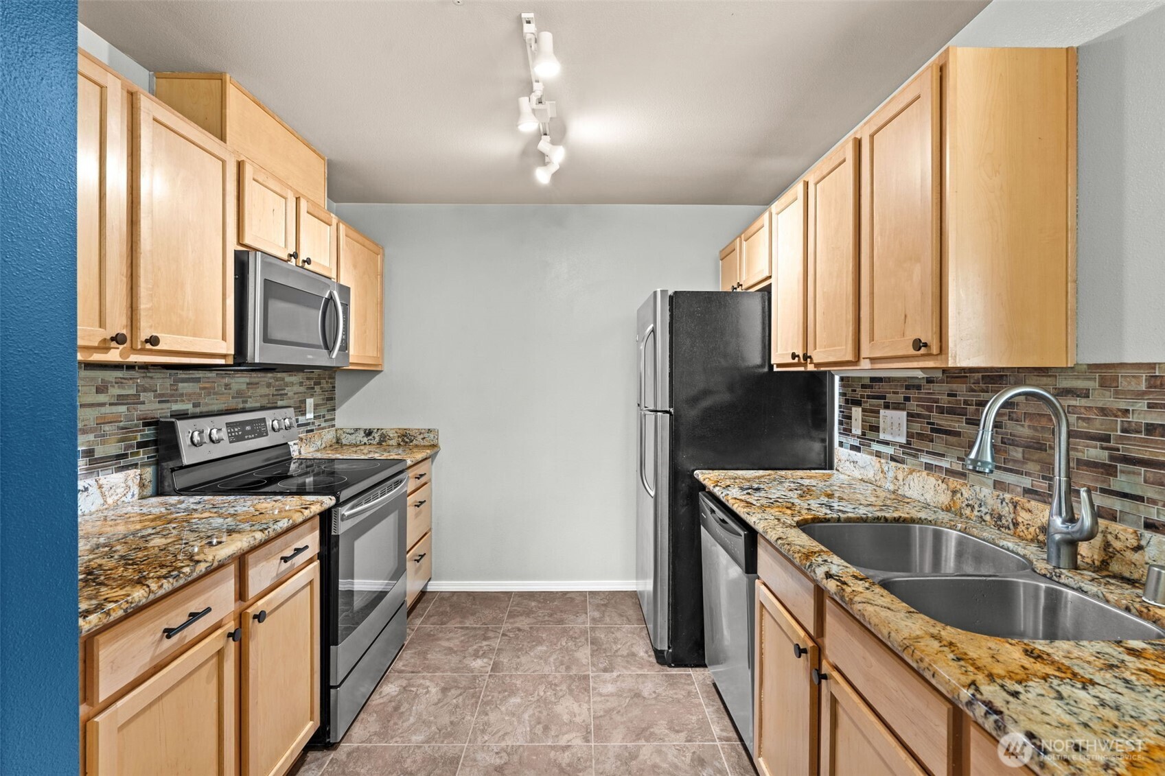 6137 Hazel Loop Southeast, Unit A8 Auburn, WA 98092 - Photo 14 of 40 a kitchen with stainless steel appliances granite countertop a sink stove and refrigerator