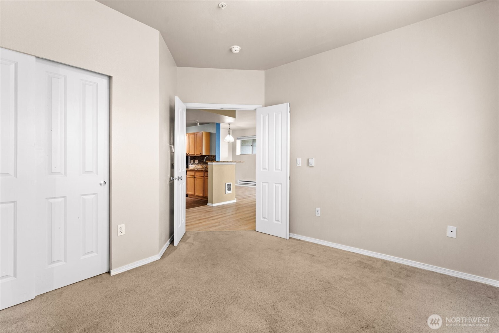 6137 Hazel Loop Southeast, Unit A8 Auburn, WA 98092 - Photo 19 of 40 an empty room with windows and entrance to other room