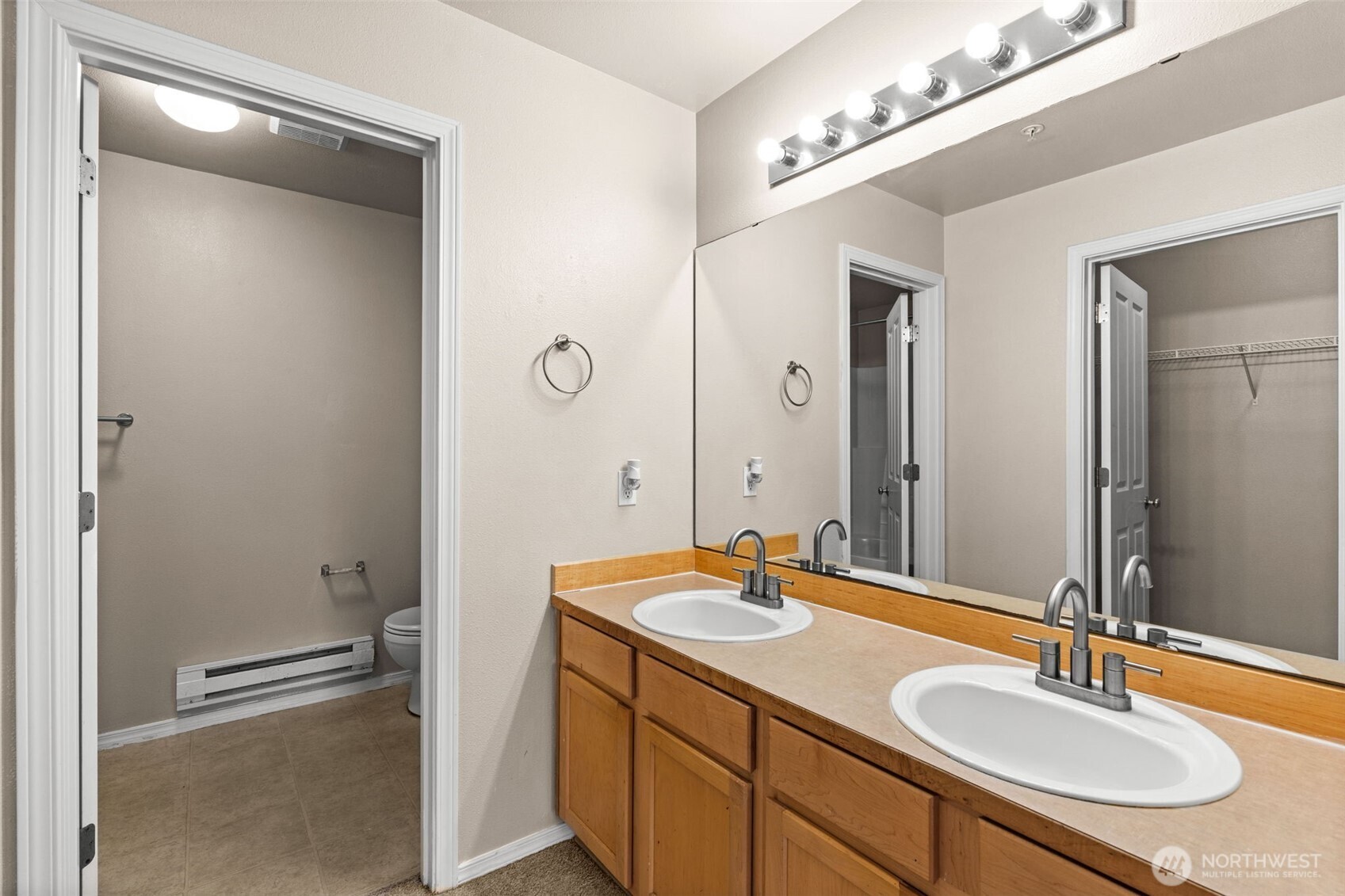 6137 Hazel Loop Southeast, Unit A8 Auburn, WA 98092 - Photo 23 of 40 a bathroom with a sink double vanity and a mirror