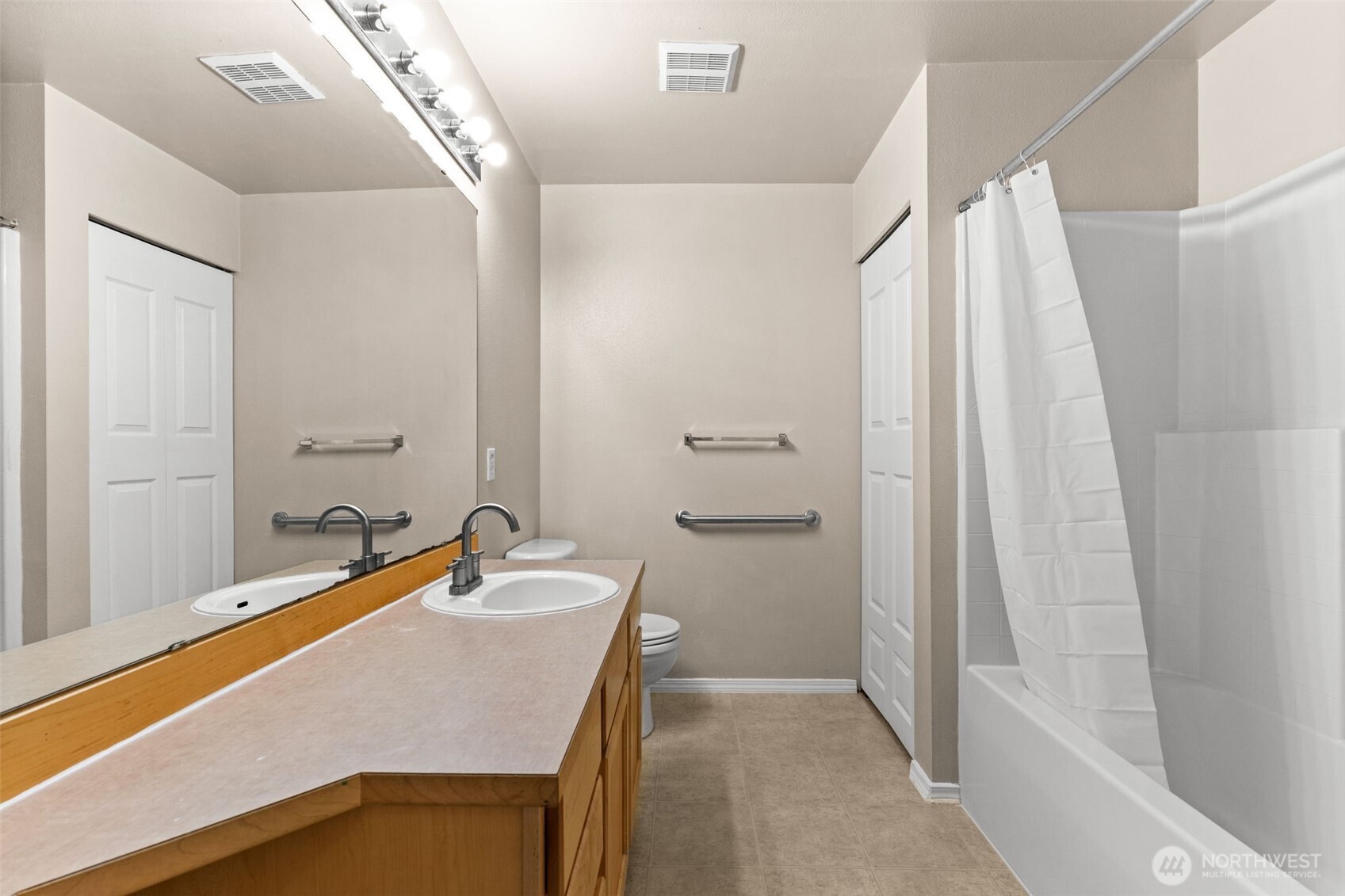 6137 Hazel Loop Southeast, Unit A8 Auburn, WA 98092 - Photo 26 of 40 a bathroom with a sink and a mirror