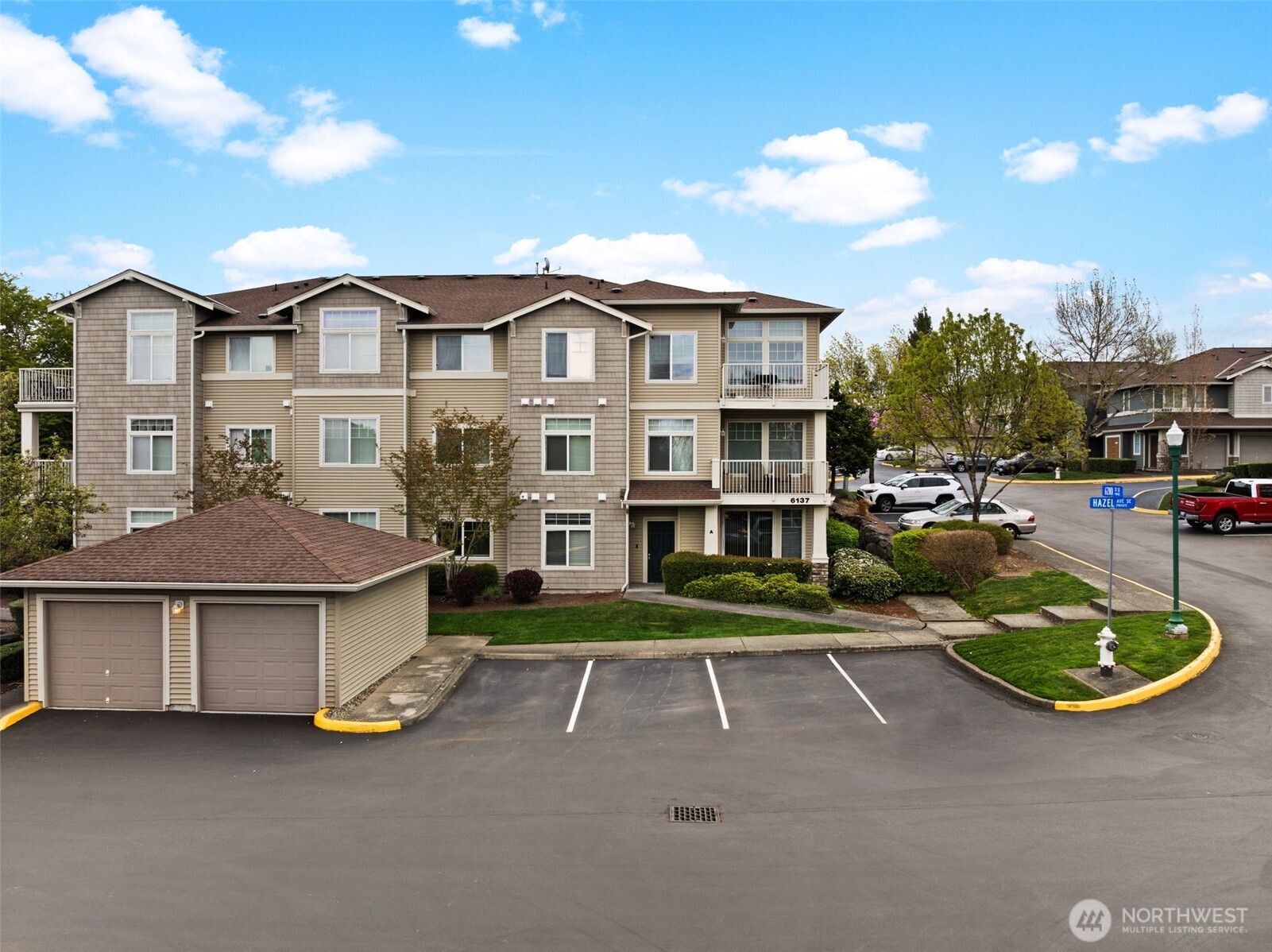6137 Hazel Loop Southeast, Unit A8 Auburn, WA 98092 - Photo 35 of 40 a view of a house with a garden and parking space