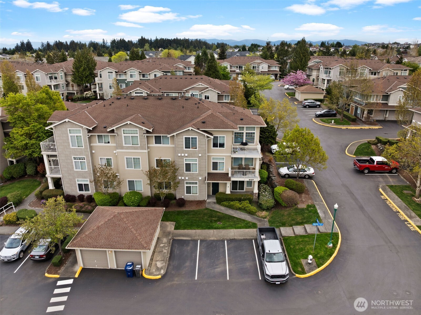 6137 Hazel Loop Southeast, Unit A8 Auburn, WA 98092 - Photo 36 of 40 an aerial view of a house with a garden and lake view