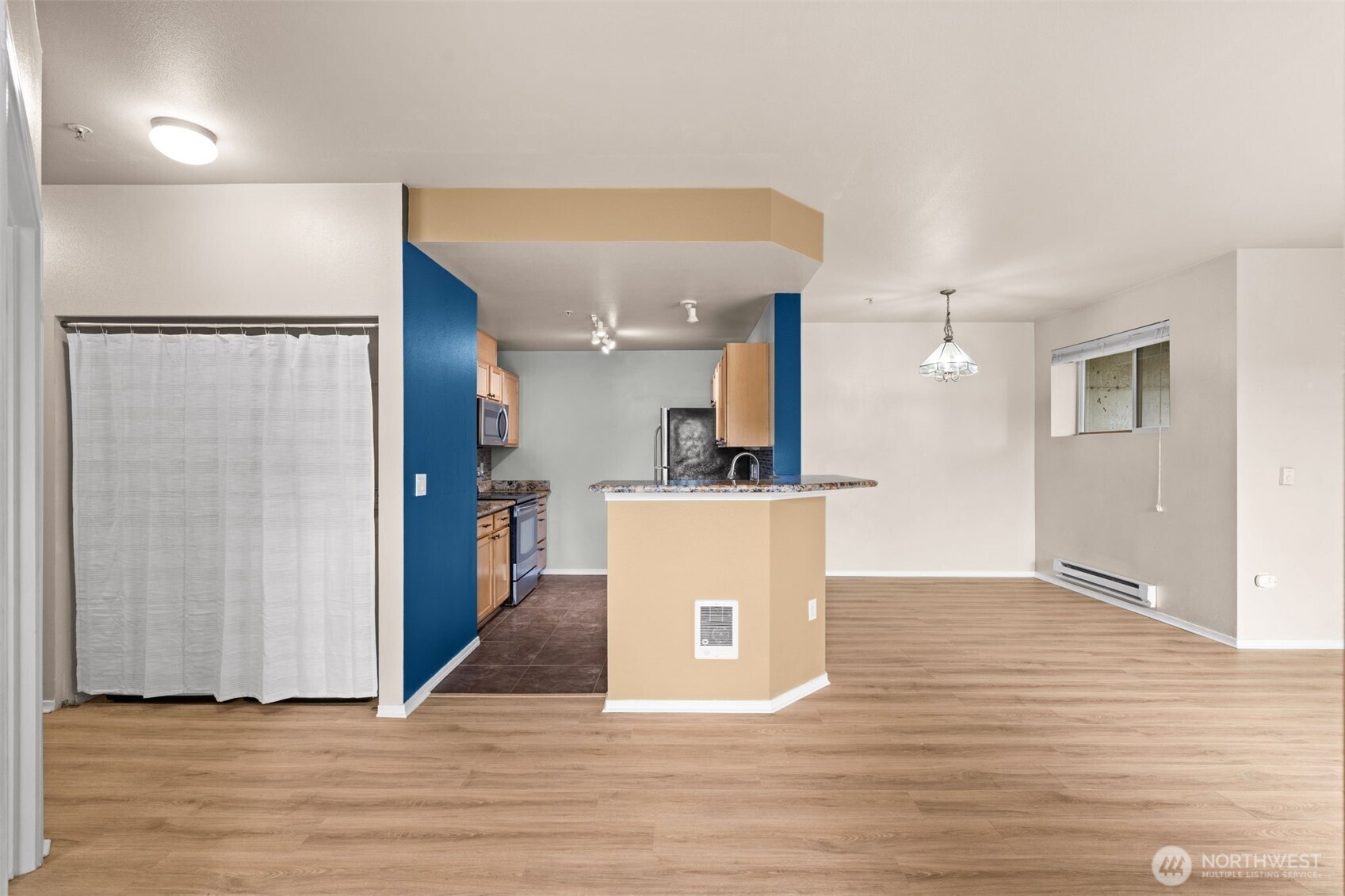 6137 Hazel Loop Southeast, Unit A8 Auburn, WA 98092 - Photo 5 of 40 a view of a living room with wooden floor and a large window