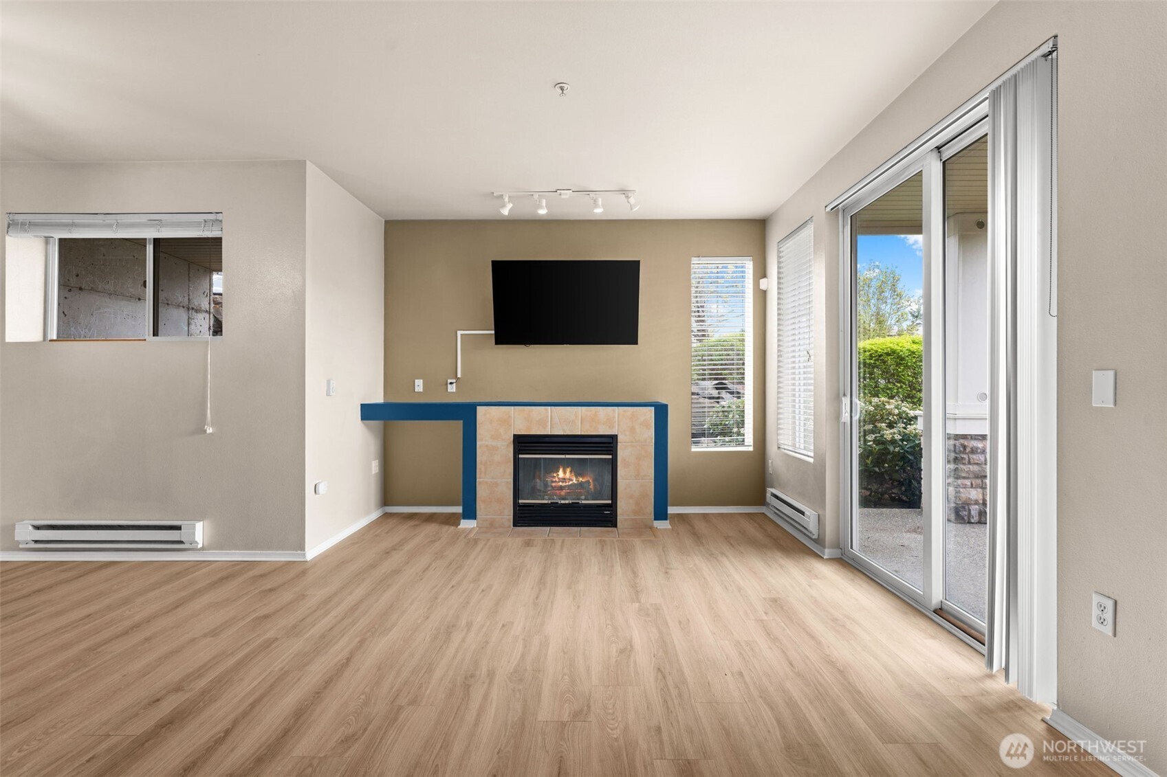 6137 Hazel Loop Southeast, Unit A8 Auburn, WA 98092 - Photo 6 of 40 a living room with a fireplace and a flat screen tv