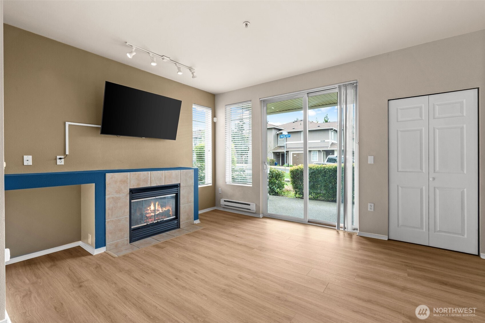 6137 Hazel Loop Southeast, Unit A8 Auburn, WA 98092 - Photo 7 of 40 a view of a livingroom with a fireplace wooden floor and window