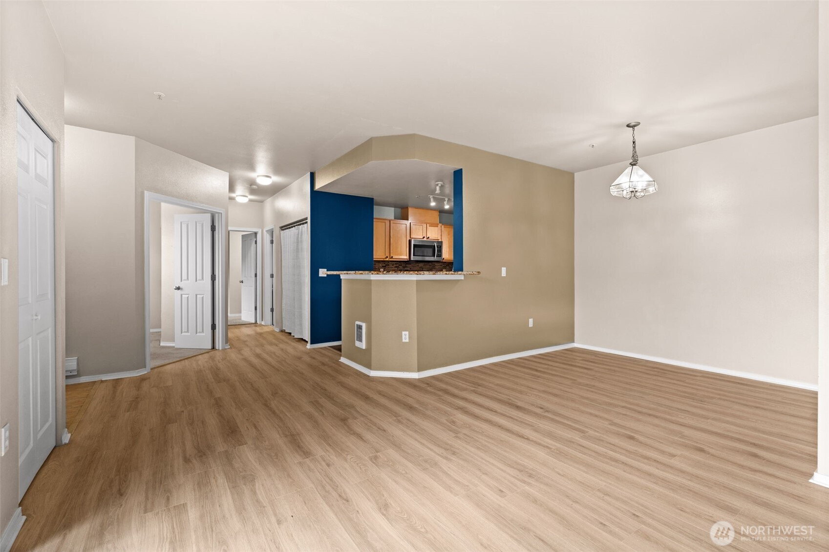6137 Hazel Loop Southeast, Unit A8 Auburn, WA 98092 - Photo 9 of 40 a view of a kitchen with wooden floor and a kitchen space