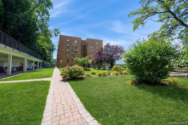 a view of a garden with a building in the background