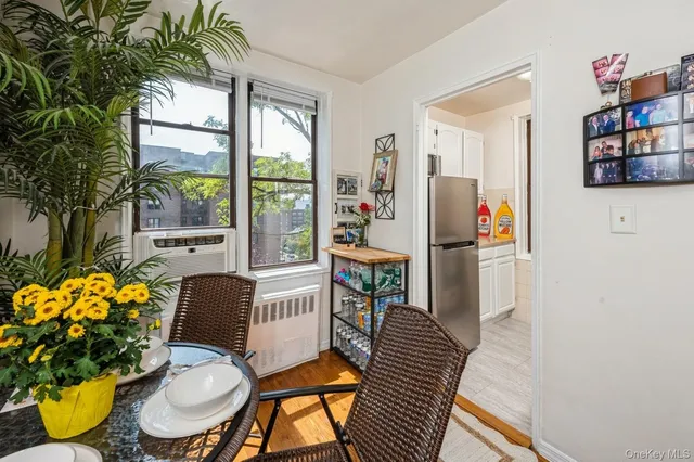 a dining room with furniture a rug and wooden floor