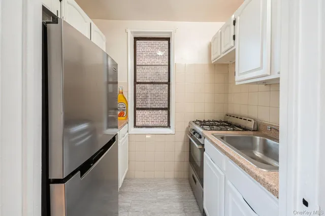 a kitchen with a refrigerator stove and sink