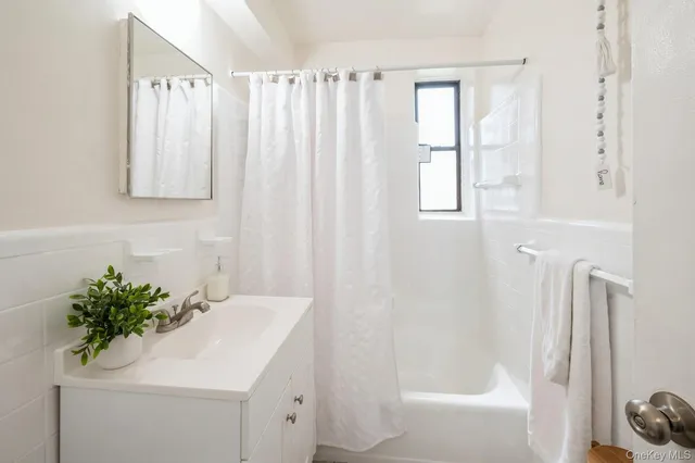 a bathroom with a sink a mirror and a shower