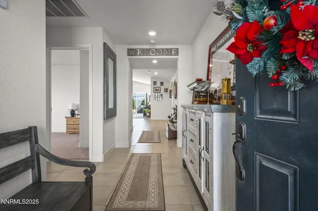 a view of a hallway and a livingroom with furniture