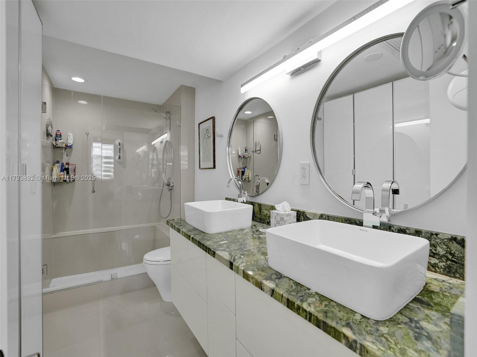 200 Ocean Ln Drive, Unit 803 Key Biscayne, FL 33149 - Photo 11 of 21 a bathroom with a granite countertop sink a mirror and shower
