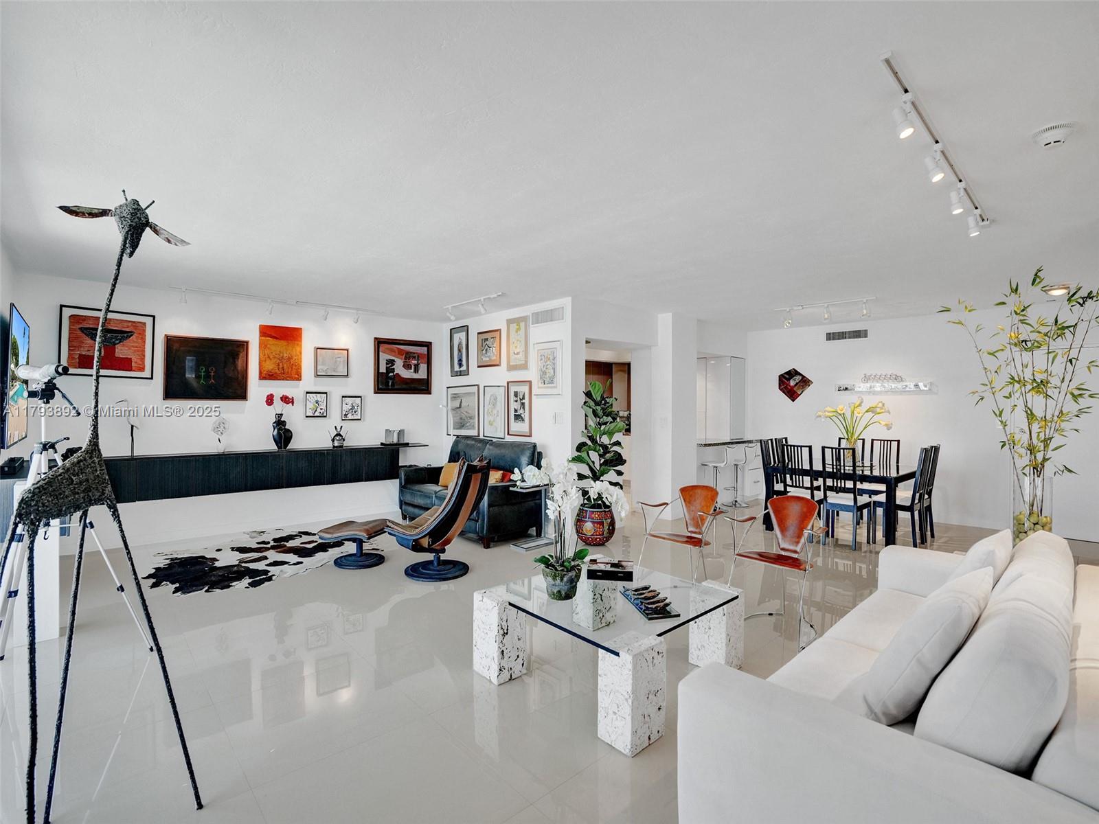 200 Ocean Ln Drive, Unit 803 Key Biscayne, FL 33149 - Photo 5 of 21 a living room with furniture a flat screen tv and a table