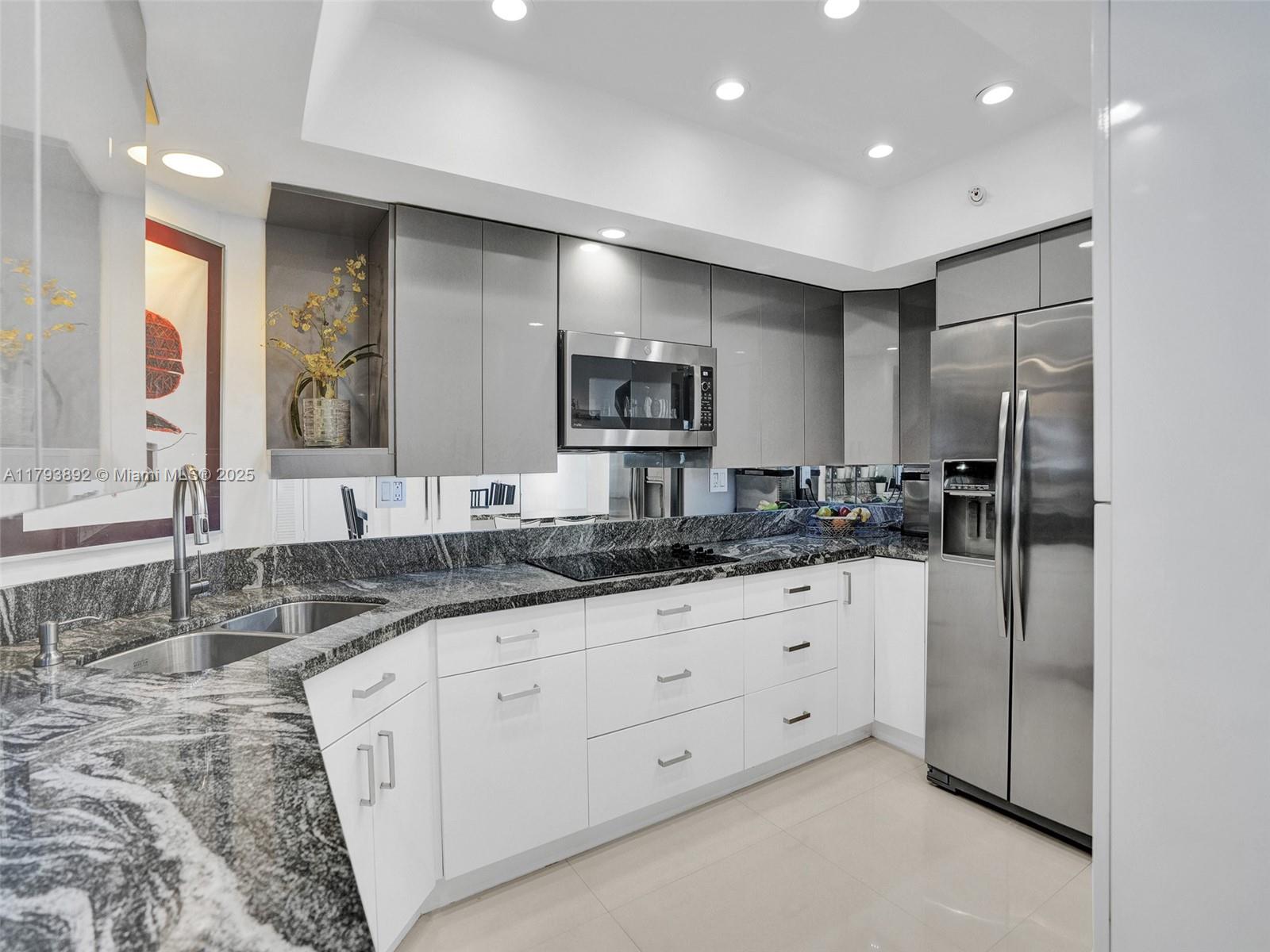 200 Ocean Ln Drive, Unit 803 Key Biscayne, FL 33149 - Photo 7 of 21 a bathroom with double sink and a large mirror