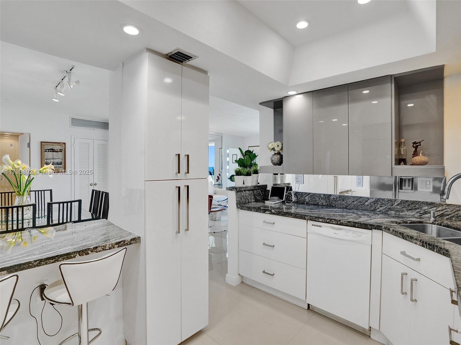 200 Ocean Ln Drive, Unit 803 Key Biscayne, FL 33149 - Photo 8 of 21 a kitchen with granite countertop a sink and cabinets