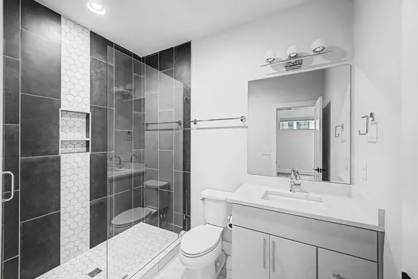 a bathroom with a sink toilet and shower