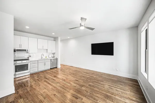a kitchen with stainless steel appliances a refrigerator and a stove top oven