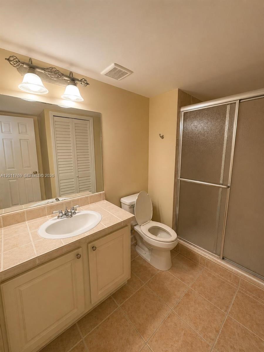 286 Racquet Club Road, Unit 204 Weston, FL 33326 - Photo 9 of 11 a bathroom with a granite countertop sink toilet and shower