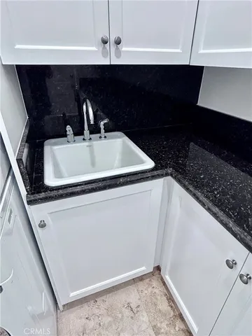 a bathroom with a granite countertop sink a toilet and shower