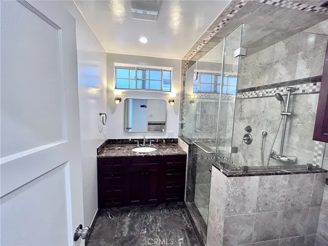 a view of a backyard with potted plants and a table and chair