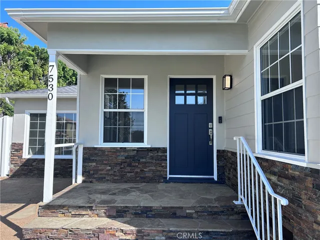 wooden floor fireplace and windows in an empty room