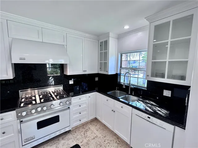 a white stove top oven sitting inside of a kitchen