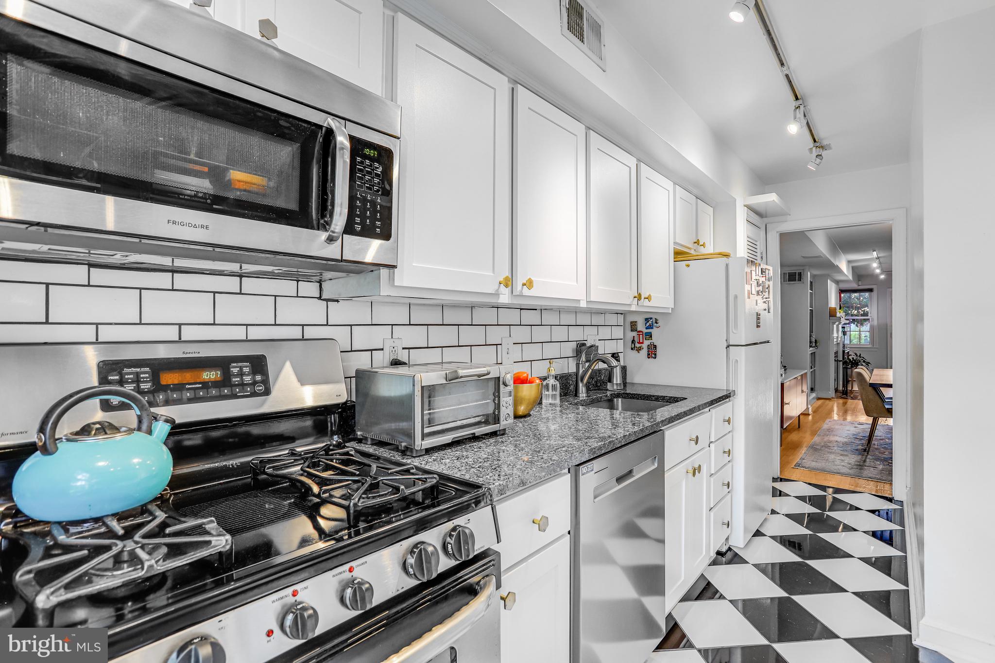 213 9th Street Southeast Washington, DC 20003 - Photo 14 of 74 a kitchen with stainless steel appliances granite countertop a stove and a sink