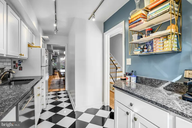 a living room with dining table and a couch