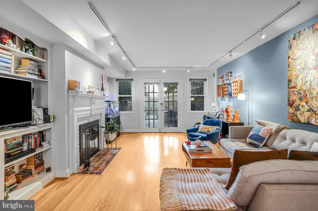 a bedroom with furniture and a large window