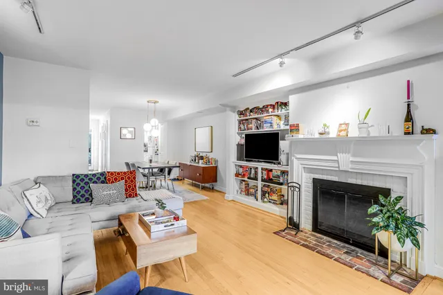 a view of a hallway with wooden floor and closet