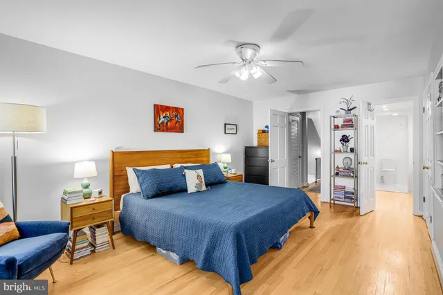 a bedroom with furniture and a book shelf