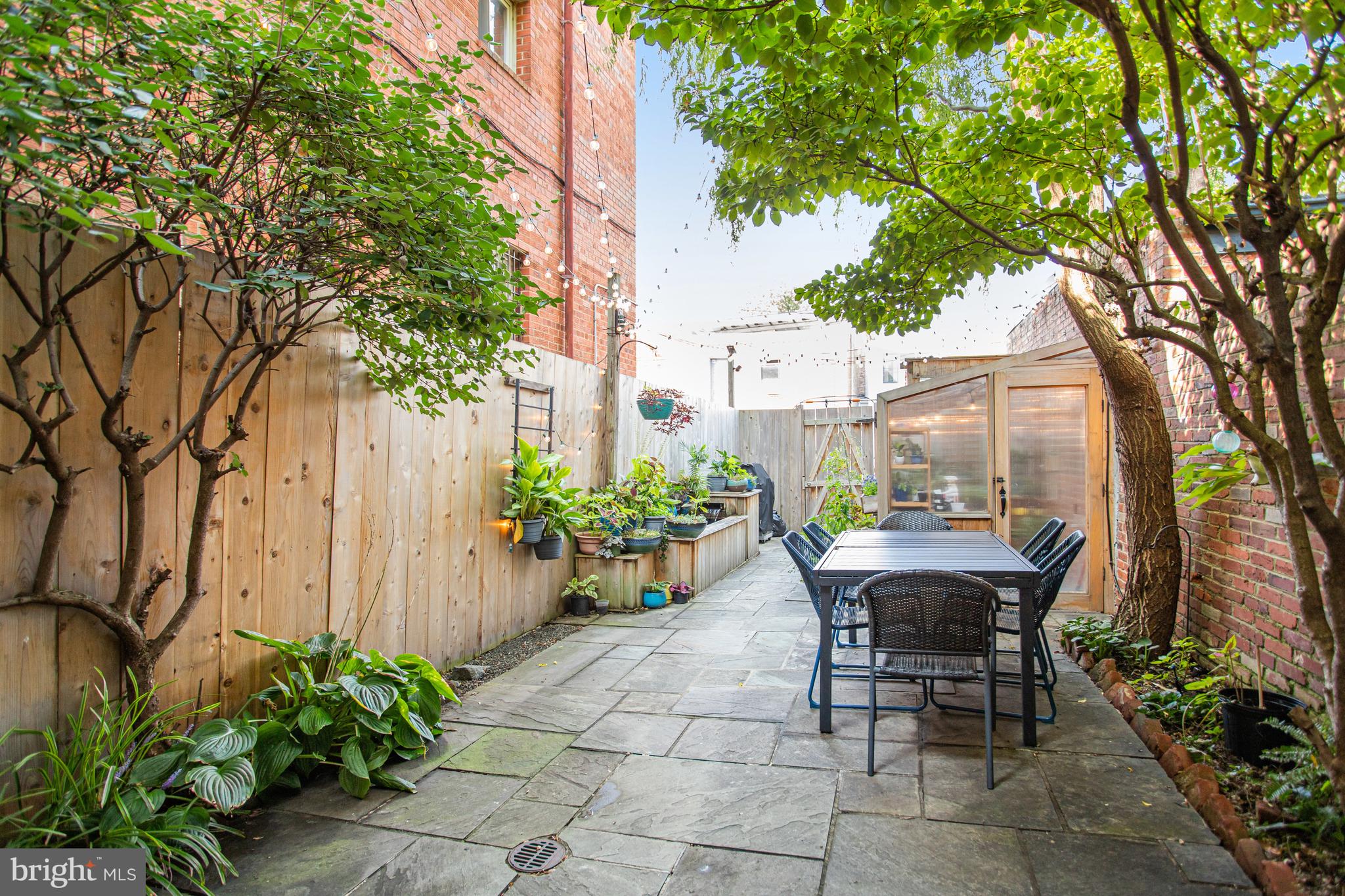 213 9th Street Southeast Washington, DC 20003 - Photo 69 of 74 a view of a dinning table and chairs in backyard of the house