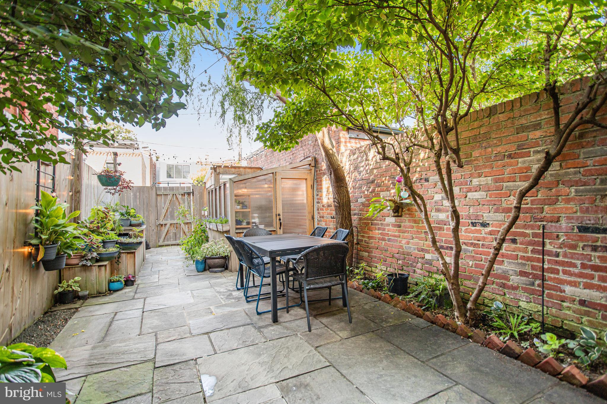 213 9th Street Southeast Washington, DC 20003 - Photo 70 of 74 a backyard of a house with barbeque oven table and chairs