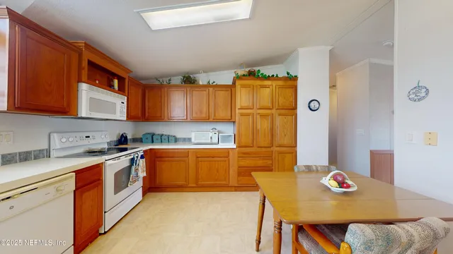 a kitchen with stainless steel appliances granite countertop a sink and a refrigerator