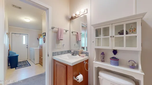 a bathroom with a sink vanity and a mirror