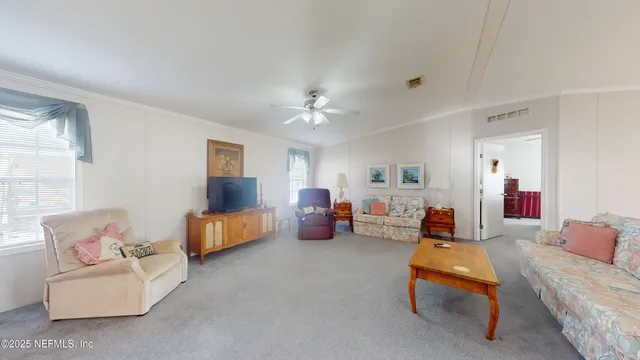 a living room with furniture and white walls