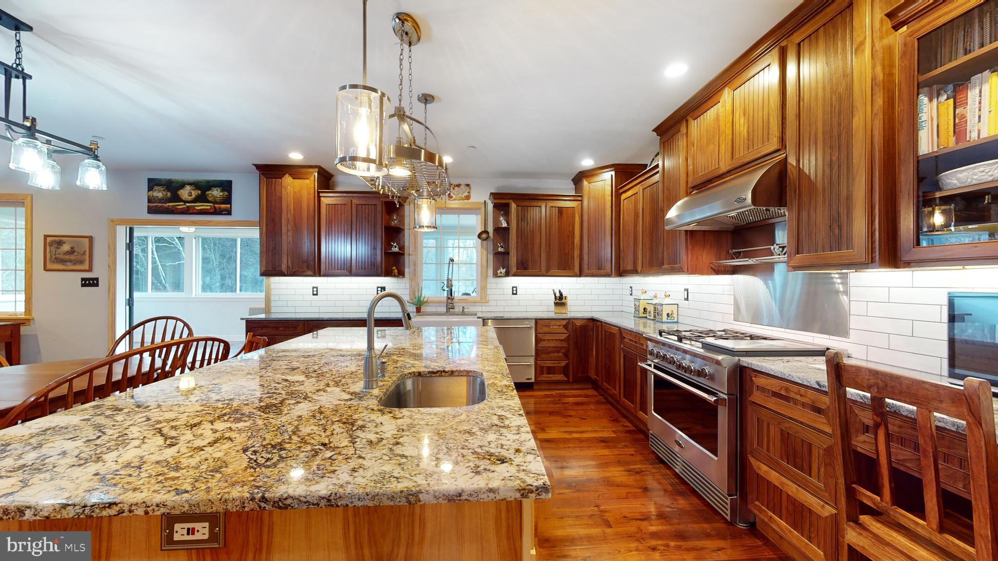 901 Crum Creek Road Springfield, PA 19064 - Photo 12 of 116 a kitchen with stainless steel appliances granite countertop a sink stove and refrigerator