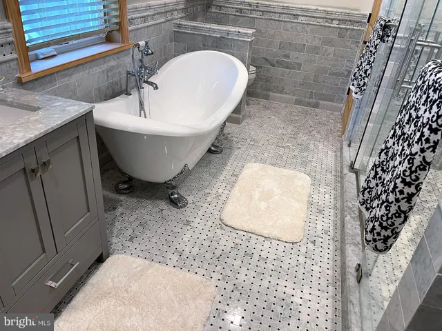 a bedroom with a bed window and a flat screen tv