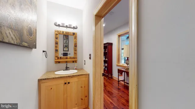 a bathroom with a toilet sink and mirror